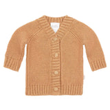 Knitted baby cardigan with buttons on a light beige background
