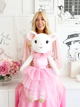 LArge Claris the Mouse plush doll sitting on the designer Megan Hess' lap