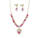 A children's jewelry set featuring a gold-tone necklace and matching clip-on earrings. The necklace has a heart-shaped pendant with a cartoon girl illustration, and the chain is decorated with pink, clear, and iridescent rhinestones.