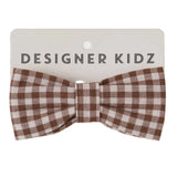 A brown and white gingham checkered bow tie displayed on a white backing card with the text 'DESIGNER KIDZ' printed in black.