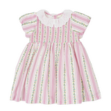 Pink and white striped girls dress with floral details on a white background