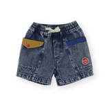 Blue denim shorts with colorful patches on a white background
