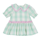 Green and white checkered girls dress with pink trim on a white background