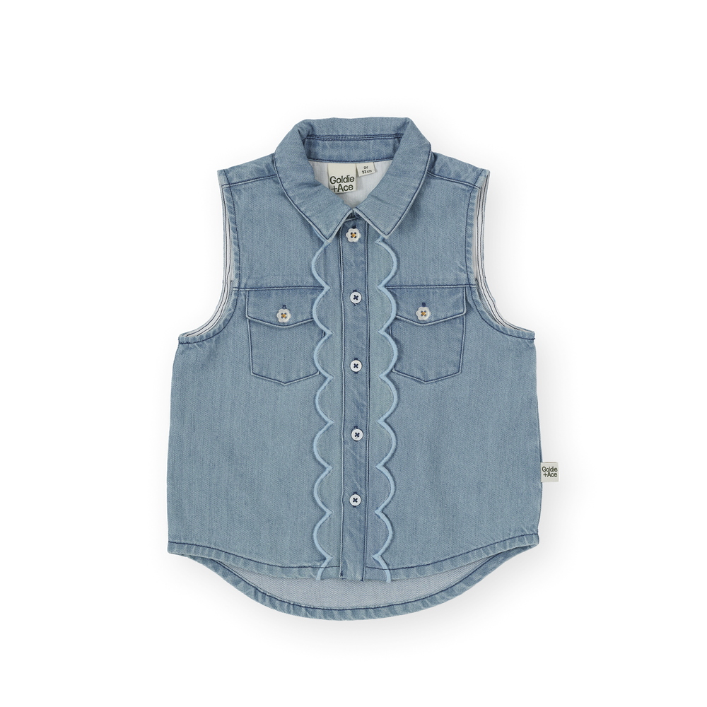 Blue denim vest with ruffled details on a white background