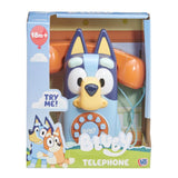 Bluey Bluey Telephone toy in its original retail packaging, featuring a light blue dog-shaped telephone with a yellow snout, blue ears, and an orange telephone receiver in the background.