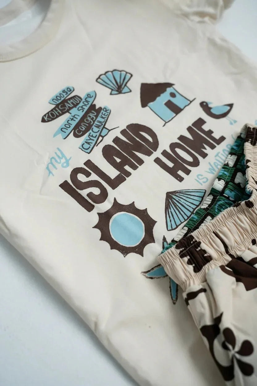 Beige t-shirt with 'My Island Home' text and island-themed graphics on a white background.