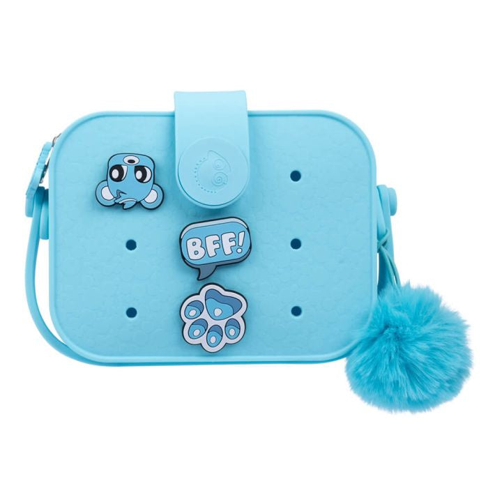 A blue handbag designed to look like a bear with interchangeable pops, including a bear face and 'BFF!' charm, and a fluffy blue pompom accessory.
