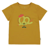 A mustard yellow classic crew neck t-shirt with a graphic of a pretzel character named Bretzel on the front.