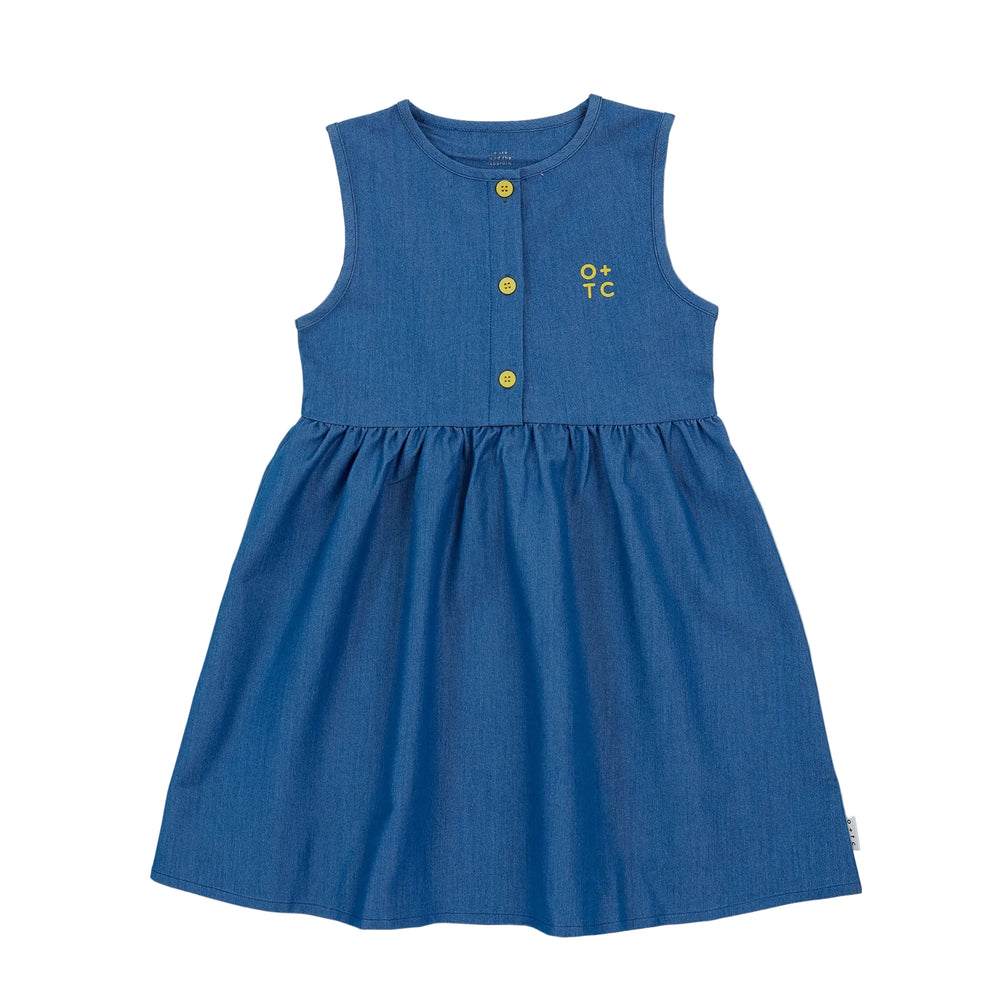 Blue light denim dress with yellow buttons on a light gray background