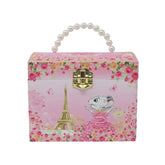 A pink decorative storage box with a pearl handle and gold clasp, decorated with floral patterns, the Eiffel Tower, butterflies, and a cartoon mouse in a pink dress.