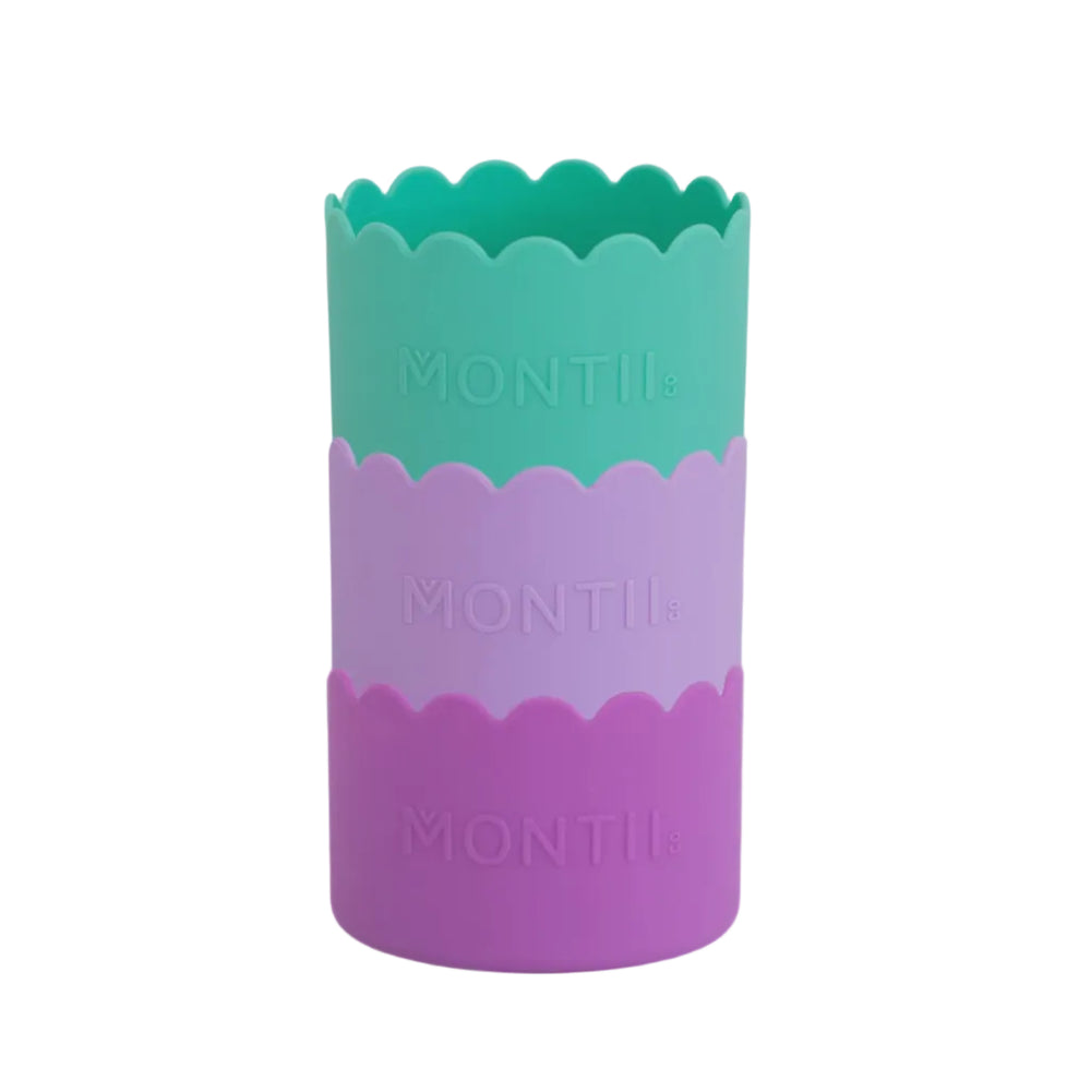 Three colours: green , light purple and purple bumper cups with 'MONTII' branding on a white background