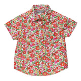 Floral boys shirt with red, pink and orange flowers on it with green leaves on a white background