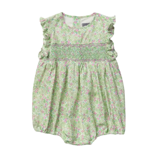 A light green baby romper with a pink green and white floral print, featuring ruffled cap sleeves and a smocked bodice, laid flat against a light gray background.