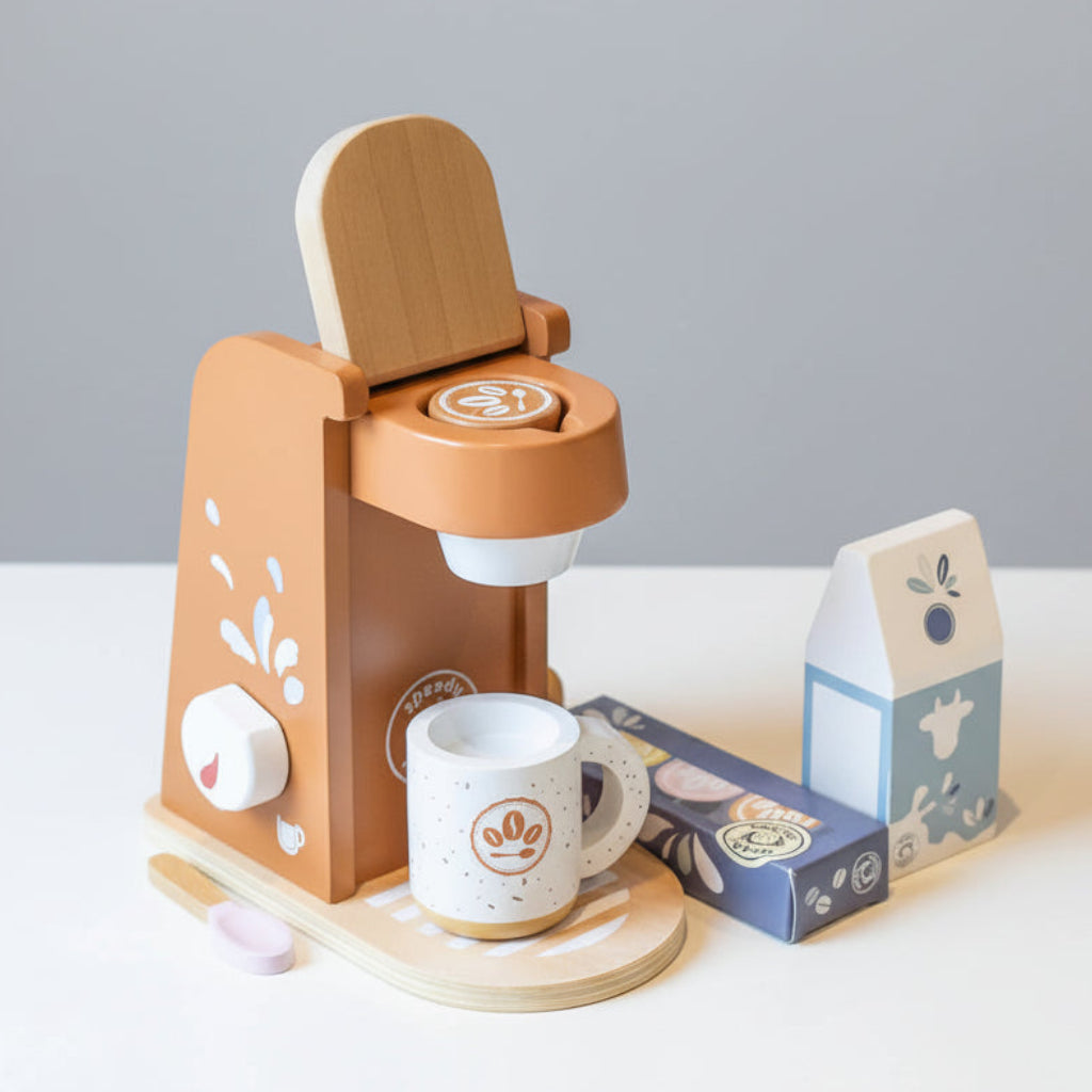 A small Toys wooden coffee maker with a cup on a light surface.