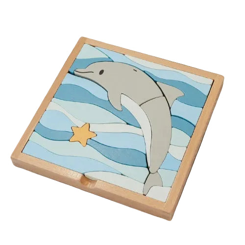 A wooden block puzzle with a dolphin shape and blue ocean waves pattern.