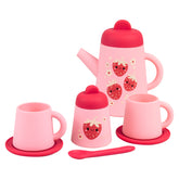 A pink silicone tea set with strawberry designs, including a teapot, cups, saucers, sugar bowl, and a spoon.