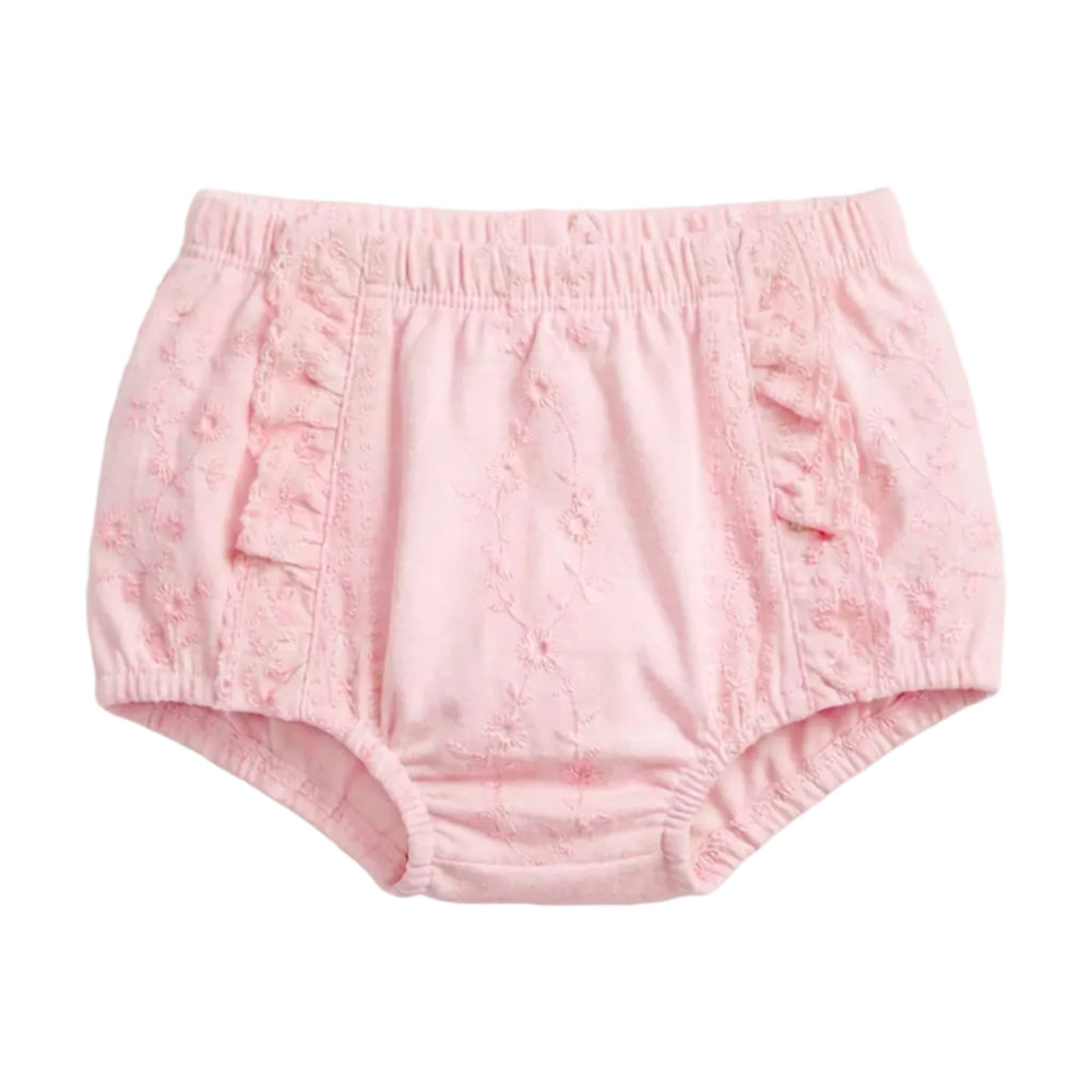 A pair of light pink toddler bloomers with a textured, embroidered fabric and ruffle details on the sides, shown against a plain light gray background.