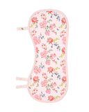 A baby feeding or nursing pad with a light pink background and a colorful floral print featuring pink, red, blue, and yellow flowers with green leaves. It has a light pink stitched border and two adjustable tabs on the left side. This burp cloth turns into a toddler bib
