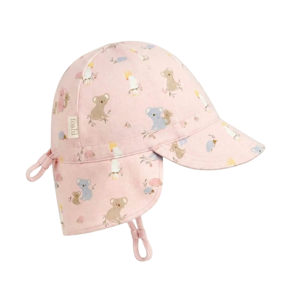 A light pink Baby flap sun hat with a curved brim and flap at the sides and back, decorated with a cute pattern of cartoon koalas, cockatoo birds, and clouds. The hat features a small fabric brand tag on the side and adjustable chin straps.