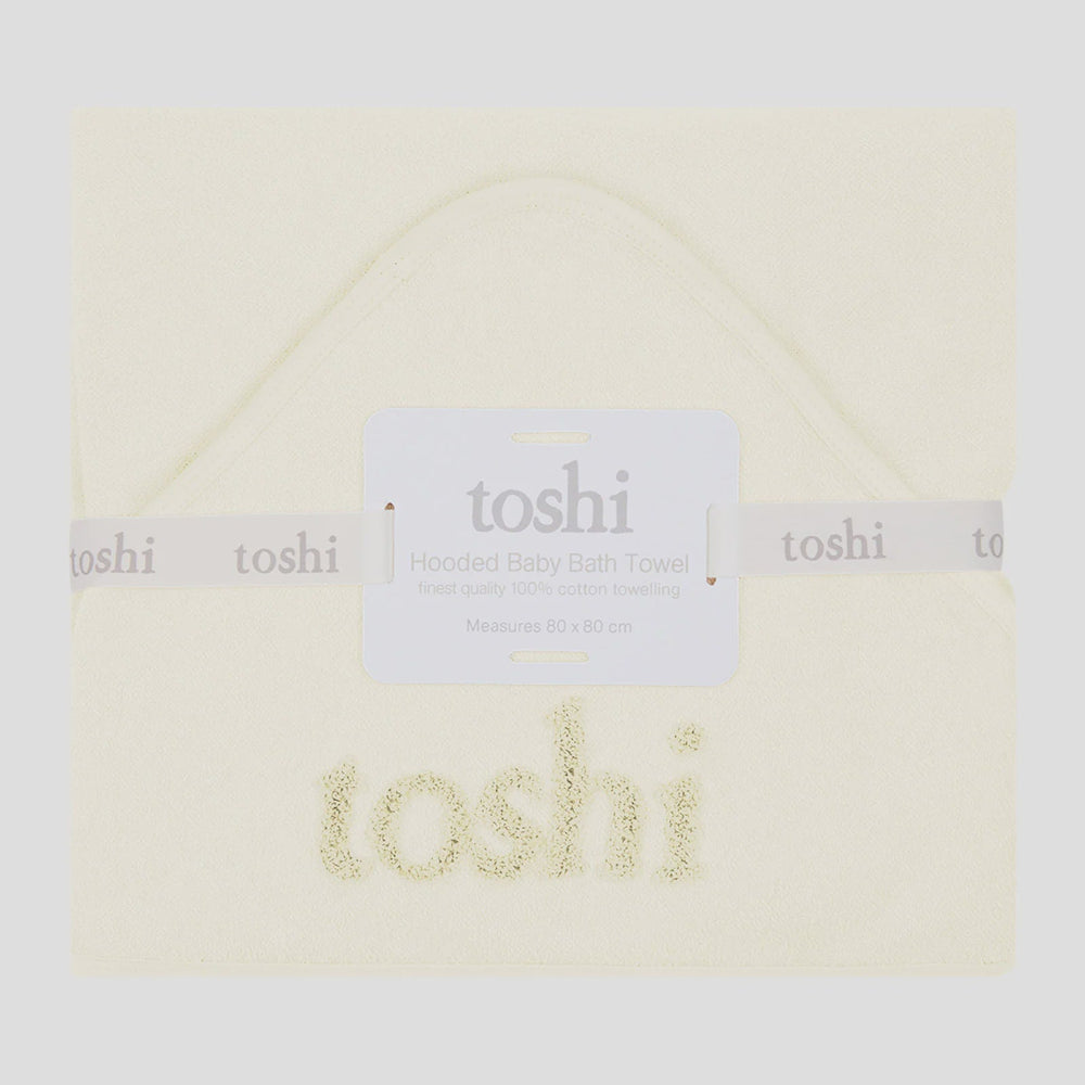 Folded baby blanket with 'toshi' branding on a white background