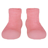 Pair of pink baby socks on a light gray background