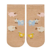 Pair of socks with farm animal pattern on a beige background