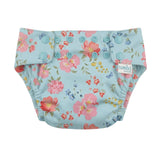 A reusable cloth swim nappy with a light blue background and a colorful floral print, featuring snap-button closures and a small 'loshi' brand tag on the side.
