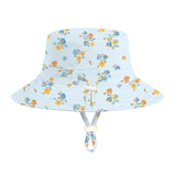 A light blue bucket hat with a yellow and blue floral pattern, featuring a chin strap with a cream-colored toggle, shown against a solid light gray background.