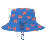 A blue bucket hat with an all-over orange crab pattern, featuring a drawstring closure on the front, photographed against a light gray background.