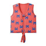 A coral orange neoprene swim life vest featuring a blue crab pattern, a front zipper, and a tie-down strap at the bottom, displayed on a light gray background.