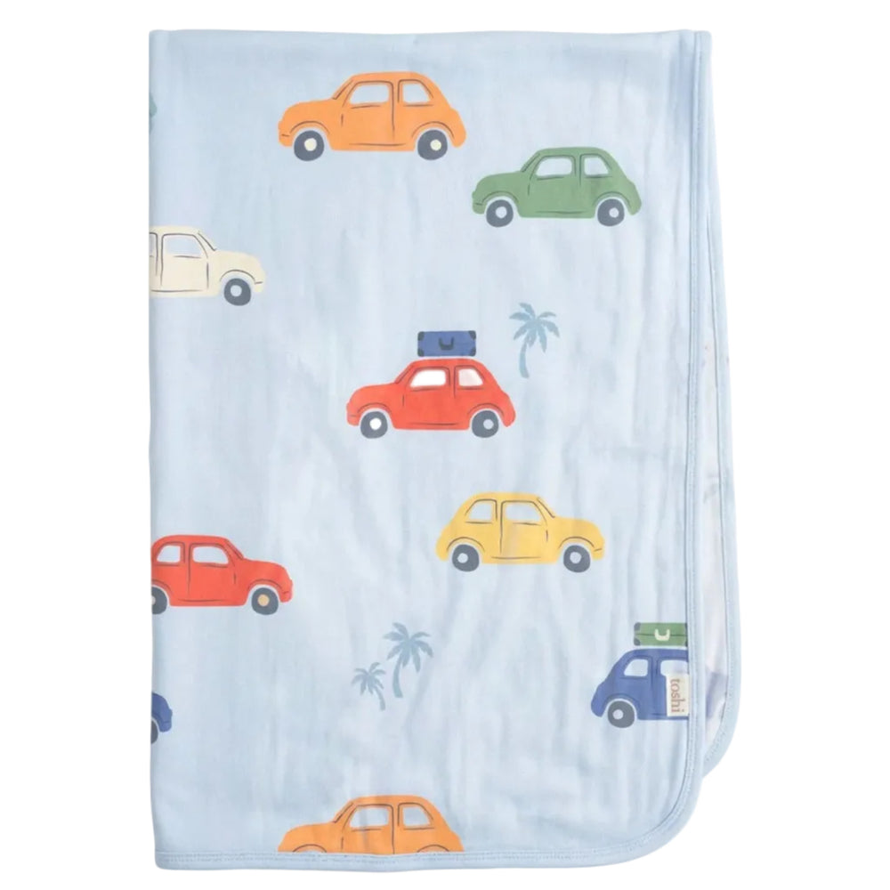 A light blue baby wrap with an all-over pattern of colorful cartoon cars and small palm trees, shown flat against a light gray background.