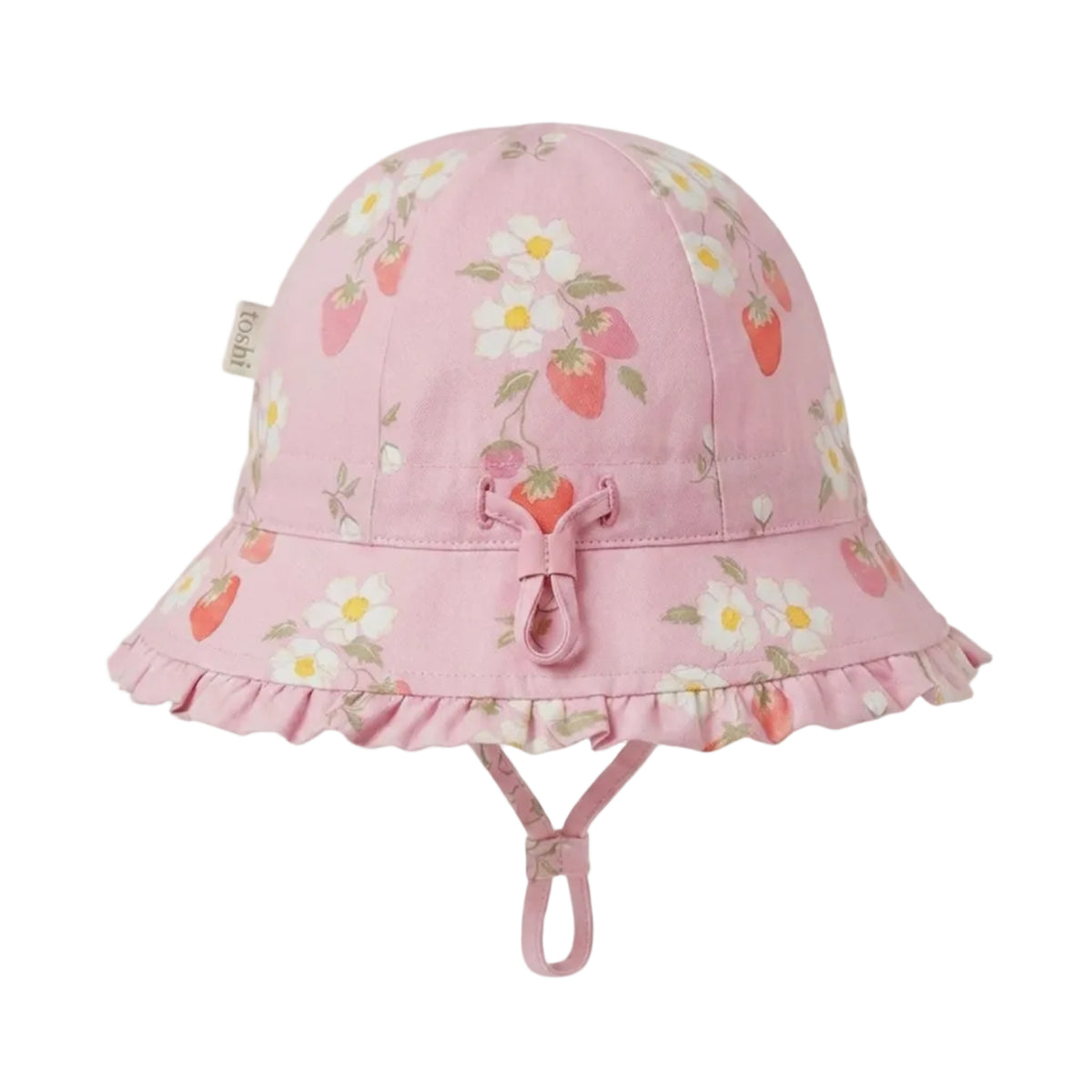A pink bucket hat for kids, featuring a strawberry and white flower pattern, a ruffled brim, and a chin strap, shown against a plain light background.