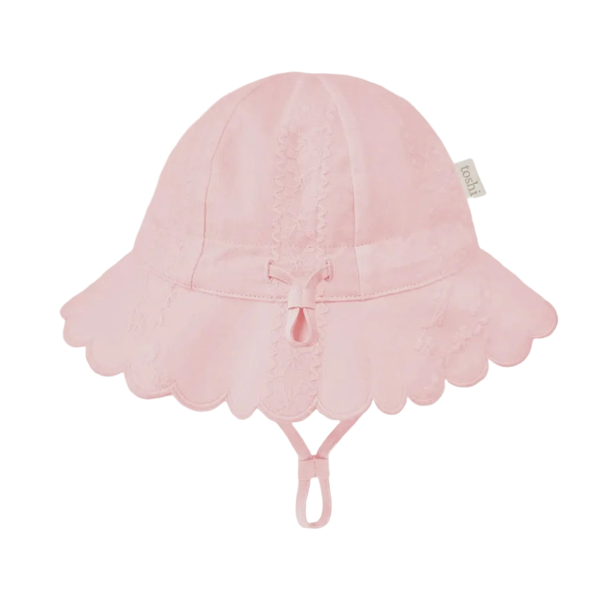 A light pink sun hat for children, featuring a scalloped lace brim, a small bow at the center, and an adjustable chin strap, shown against a solid light gray background.