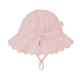 A light pink sun hat for children, featuring a scalloped lace brim, a small bow at the center, and an adjustable chin strap, shown against a solid light gray background.