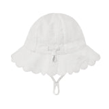 A white sun hat for children, featuring a scalloped lace brim, a central bow, and an adjustable chin strap, shown against a light gray background.