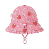 Baby bell swim hat with strawberries and white flowers on a pink background.