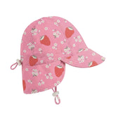 A pink baby swim hat with strawberry and white flower print