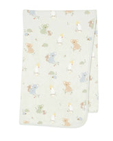 A folded knit baby blanket with a light sage green background and a playful pattern of cartoon koalas, kangaroo babies, and birds in soft pastel colors, shown on a neutral light gray background.