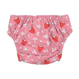 Pink reusable cloth swim nappy with a pattern of red strawberries and small white flowers, shown flat against a light gray background.