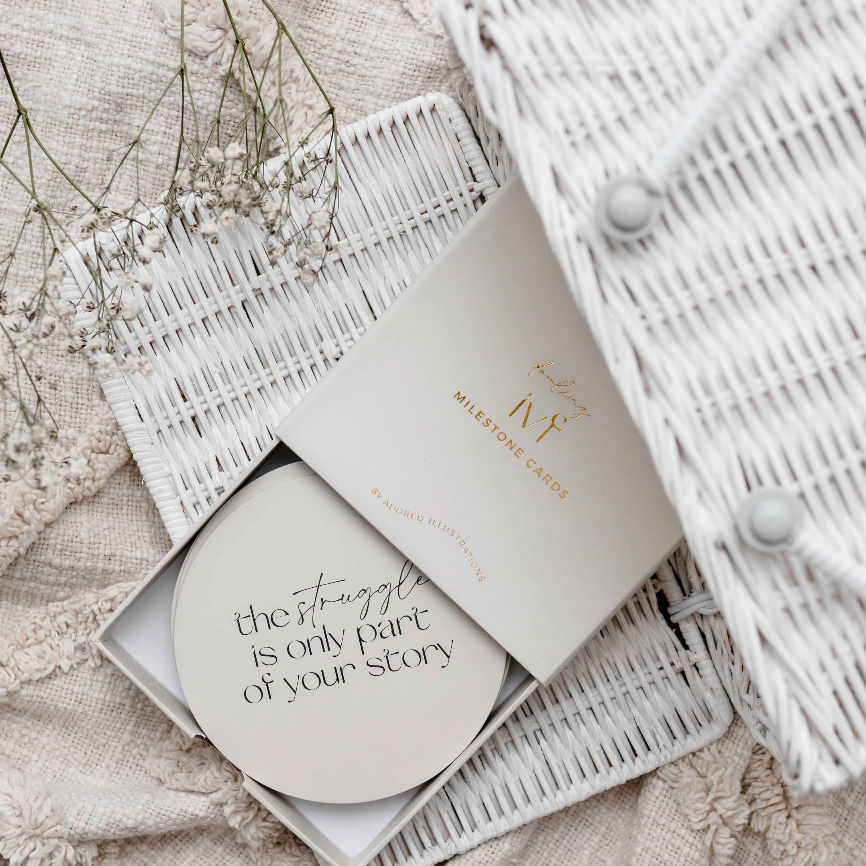 Round milestone plaque in a white box item with 'the struggle is only part of your story' text in a white box on a textured surface.