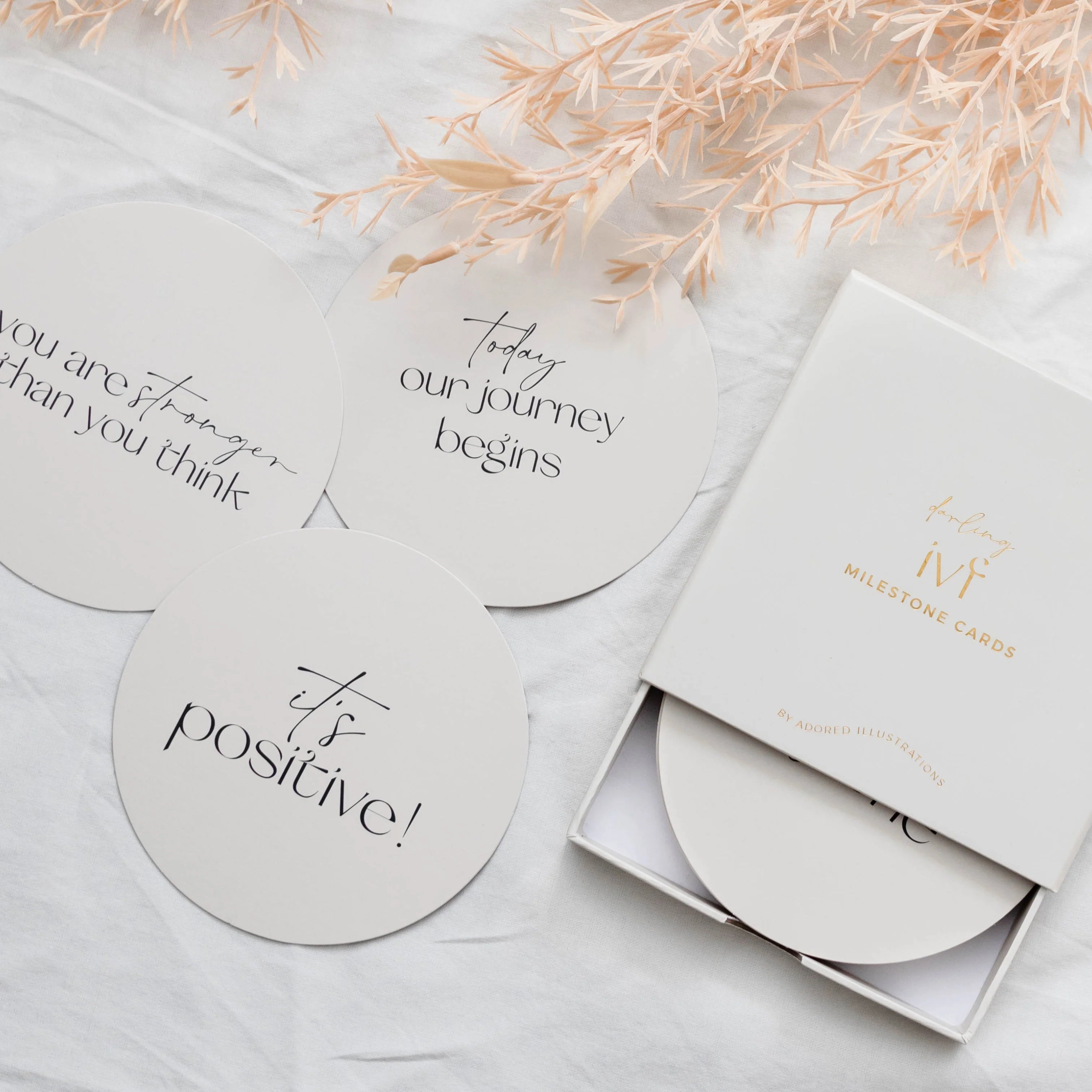 Milestone cards with motivational phrases on a light surface with decorative elements.