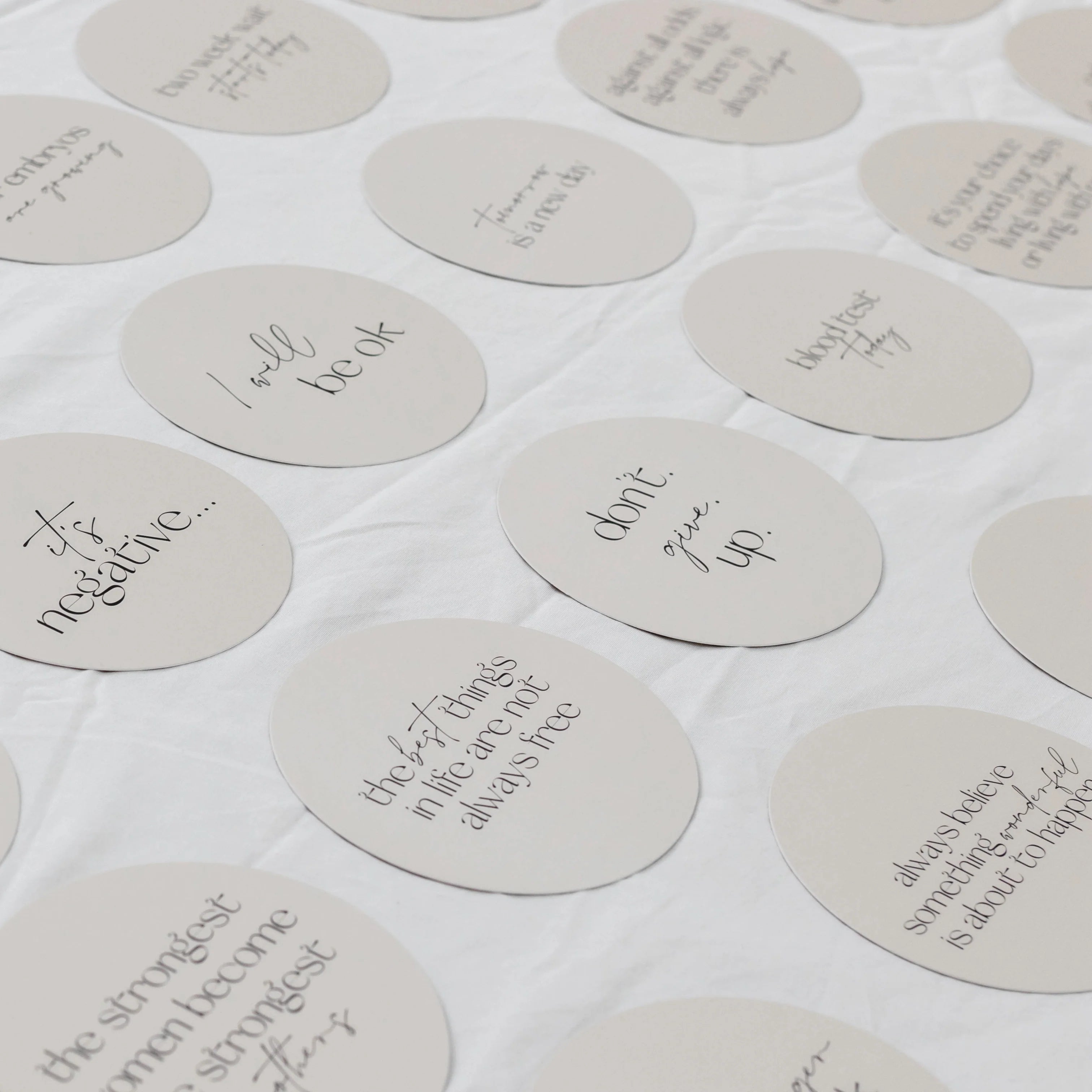 Round milestone cards with motivational phrases on a white background