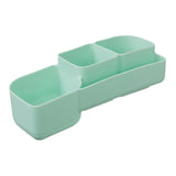 Light green rectangular silicone container with two compartments on a light gray background