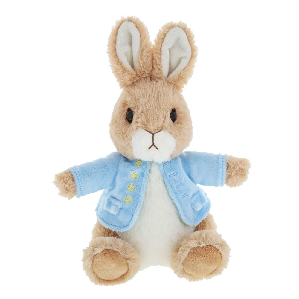 Plush toy rabbit wearing a blue coat on a white background