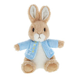 Plush toy rabbit wearing a blue coat on a white background