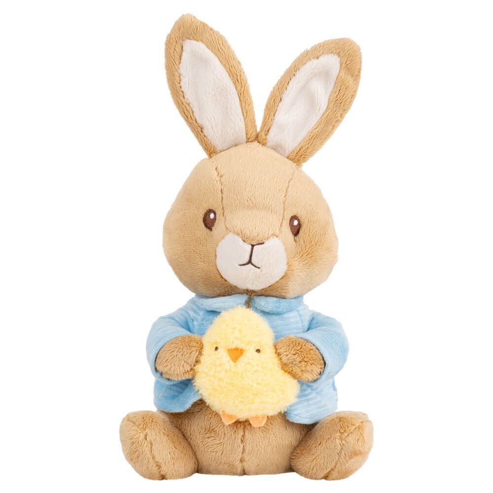 Plush toy rabbit holding a chick on a white background