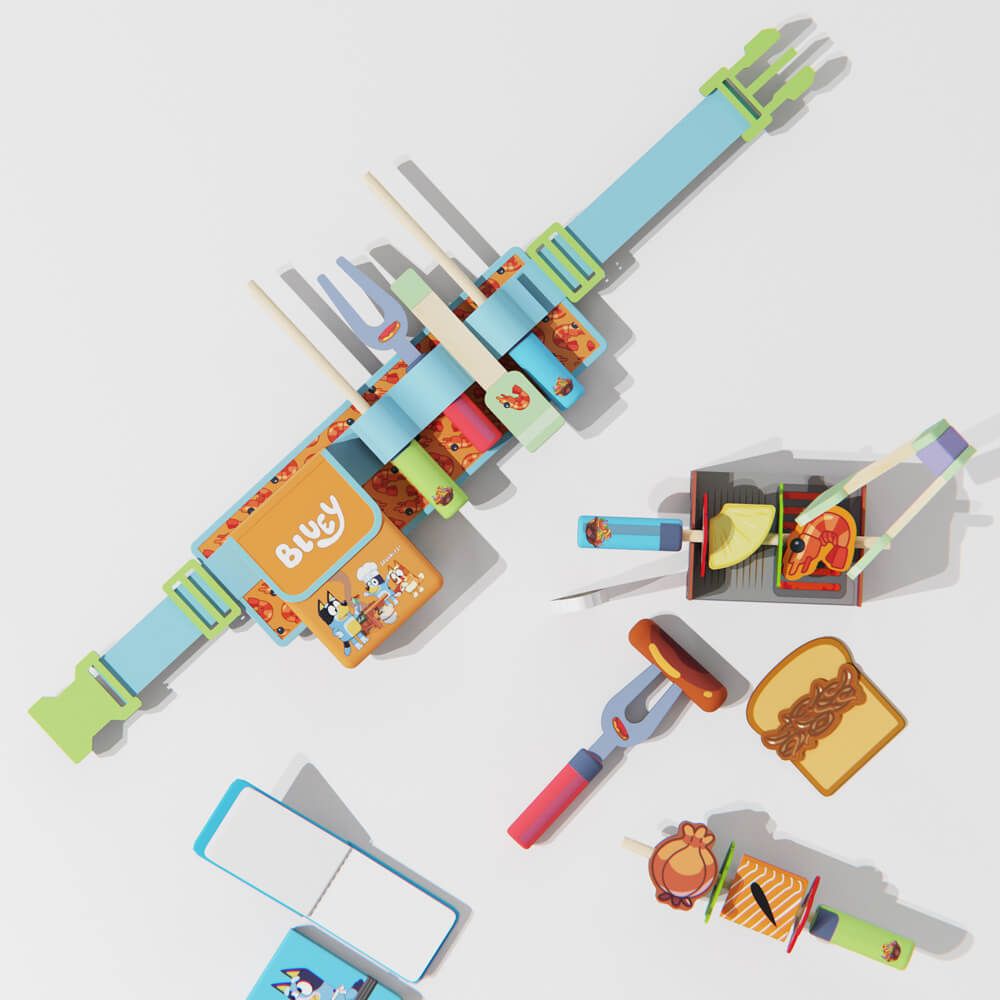 Children's  Bluey toy grill set with utensils and food items on a light gray background