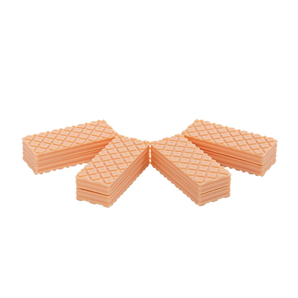 Four stacks of peach-colored waffle-pressed plastic pieces, arranged in a fan shape on a plain white background.