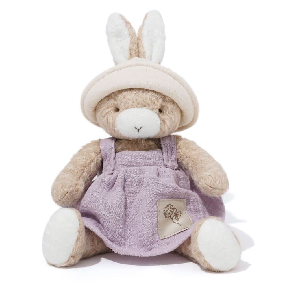 Stuffed toy with bunny ears and a purple dress on a white background