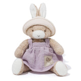 Stuffed toy with bunny ears and a purple dress on a white background